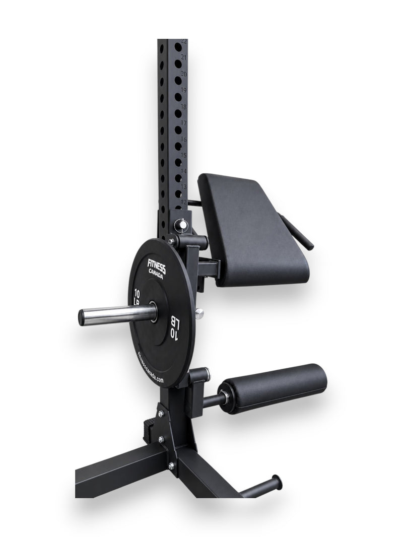 Black 3x3 inch rack-mounted leg extension and curl seat attachment with high-density foam roller pads and 10lb Olympic black bumper plate loaded onto sleeve