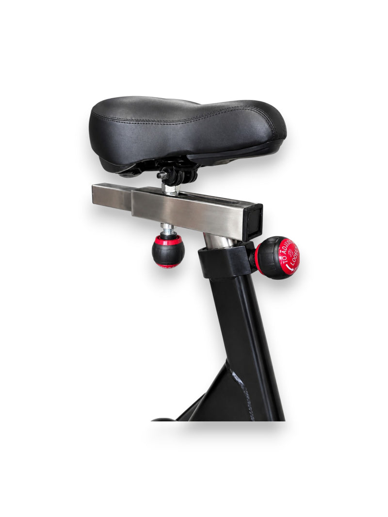 Side angle view of the black Fitness Canada air bike padded adjustable seat.